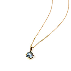Brilliant cut small 5mm blue aquamarine set in an 18kt yellow gold pendant. The pendant is hung on a fine 18kt yellow gold chain made in Italy.