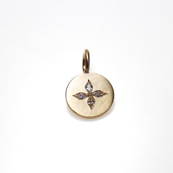 Tiny yellow gold disc pendant set with 4 small marquise diamonds in a compass style