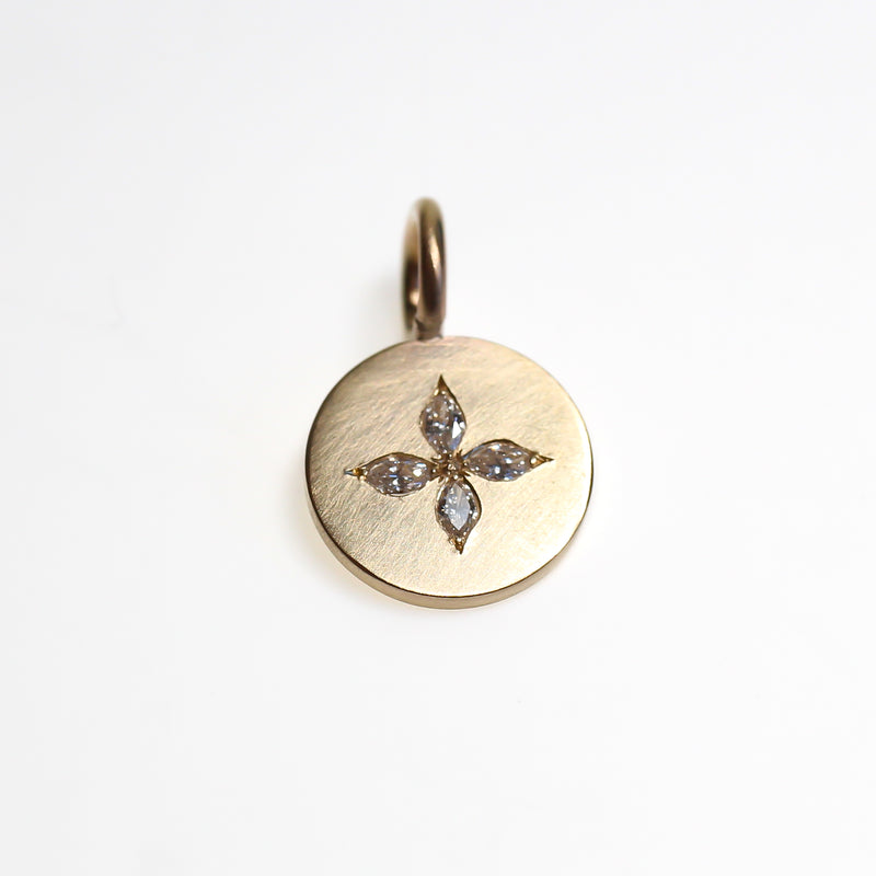 Tiny yellow gold disc pendant set with 4 small marquise diamonds in a compass style