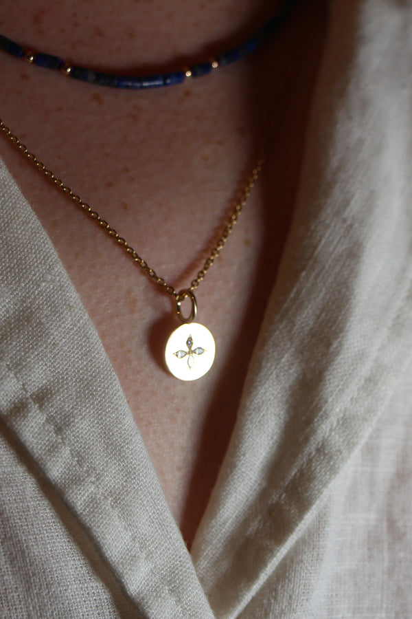 Tiny yellow gold disc pendant set with 4 small marquise diamonds in a compass style