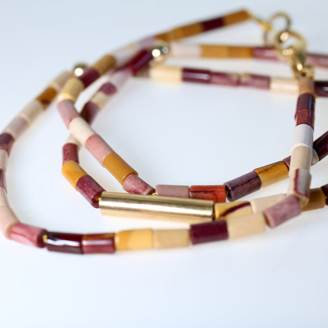 Cylinder shaped Australian jasper beads in mustard/white/red multi colours are hand knotted on thread with 14kt yellow gold beads and completed with an 18kt yellow gold clasp. By jewellery designer Tamahra Prowse.