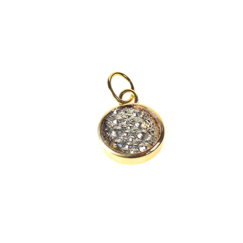 Sea urchin disc pendant in 9kt gold and silver by designer Tamahra Prowse