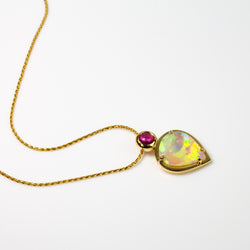 Australian crystal opal pendant set in 18 karat yellow gold with a bright pink rubellite