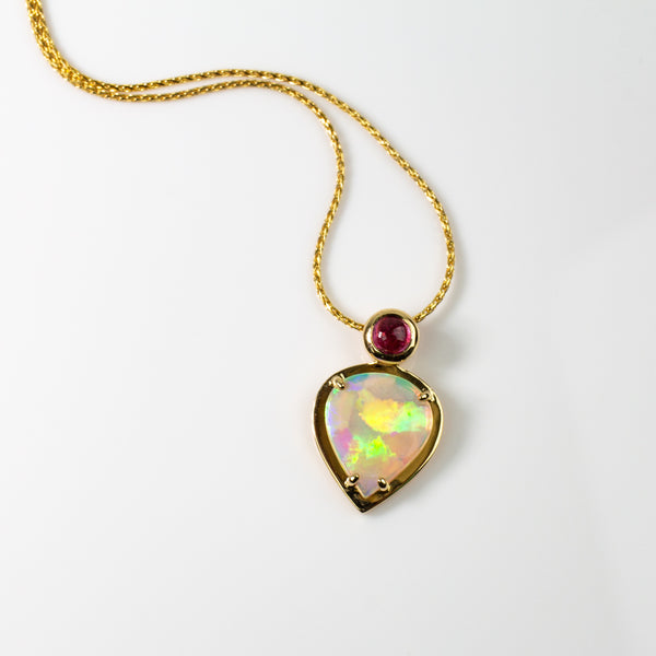 Australian crystal opal pendant set in 18 karat yellow gold with a bright pink rubellite