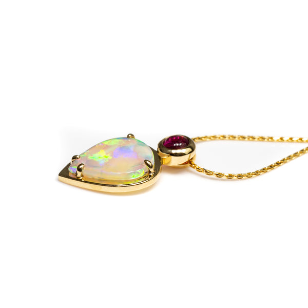Australian crystal opal pendant set in 18 karat yellow gold with a bright pink rubellite