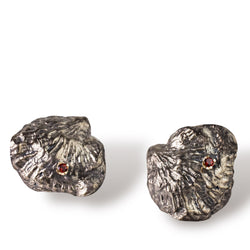 Sterling silver, 18kt gold and garnet earrings are cast from a single shell. They are large and reminiscent of an 80's power earring. Gold butterflies secure the backs. By designer Tamahra Prowse