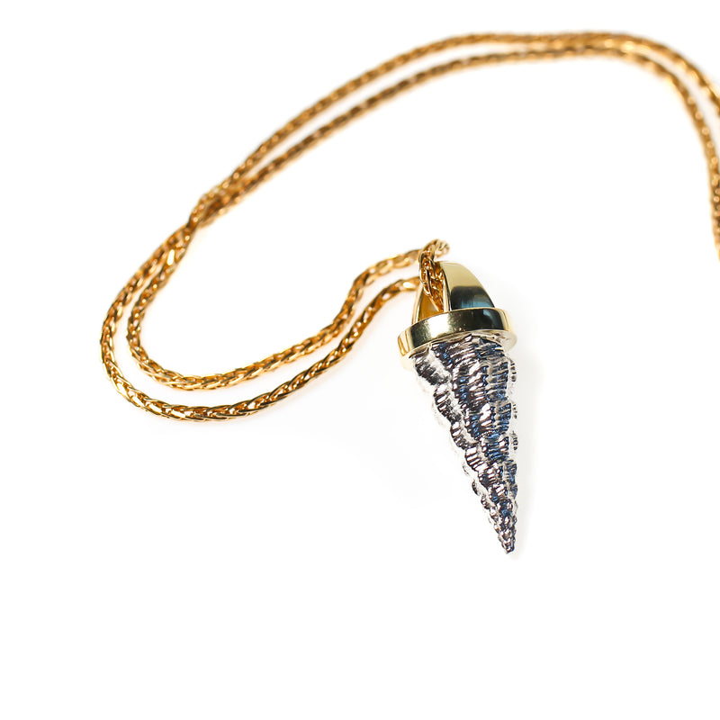 Cone shell cast  in sterling silver and mounted with heavy 18kt gold bail.