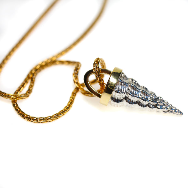 Cone shell cast  in sterling silver and mounted with heavy 18kt gold bail.