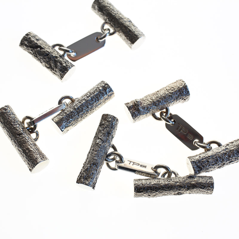 Sterling silver men's cufflinks cast from twigs, articulated bar in centre joins the two pieces.