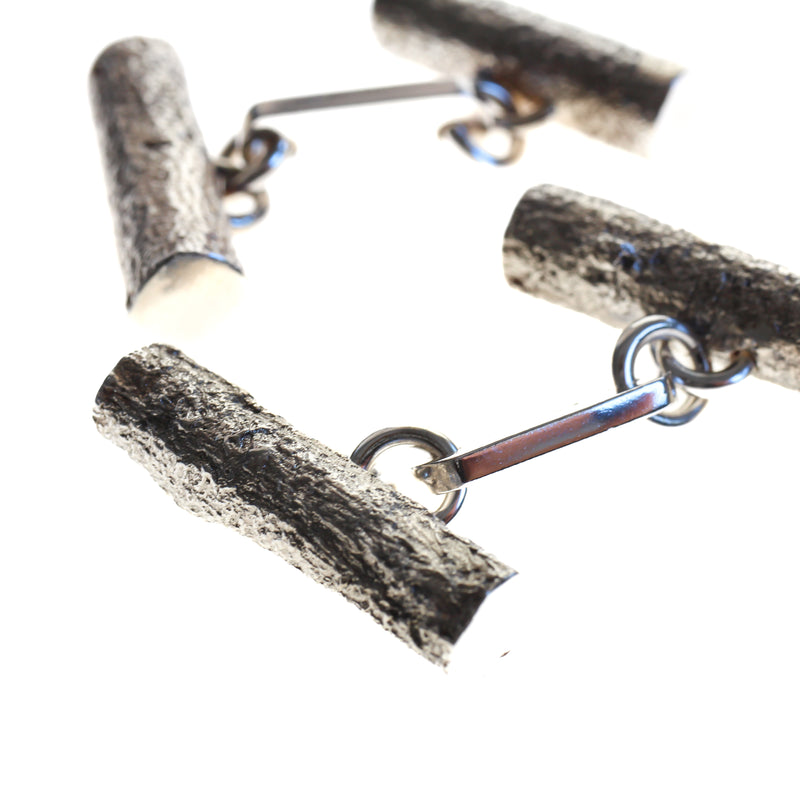 Sterling silver men's cufflinks cast from twigs, articulated bar in centre joins the two pieces.