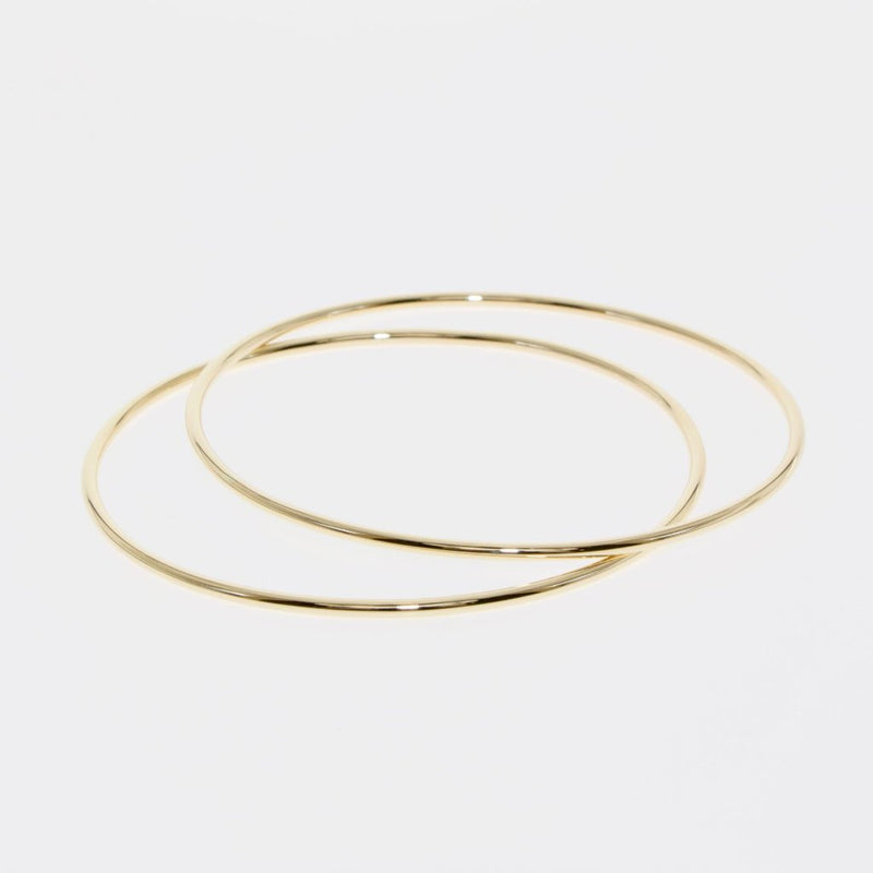 Simple Geometry series oval bangle in gold by designer Tamahra Prowse.
