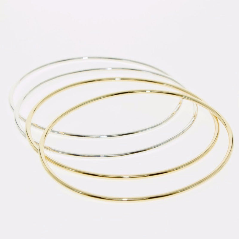 Simple Geometry series oval bangle in gold by designer Tamahra Prowse.